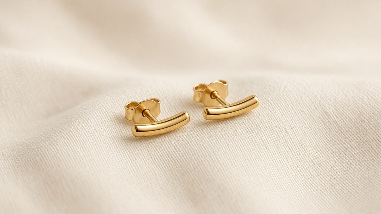 Threadline Studs in gold vermeil, on a bone studio backdrop